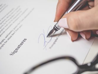 Pen signing a document